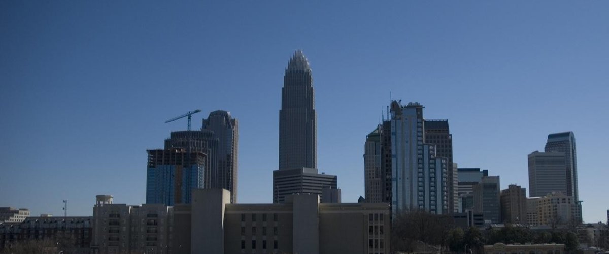 Uptown Charlotte skyline on a clear day, with the Bank of America Corporate Center tower at center