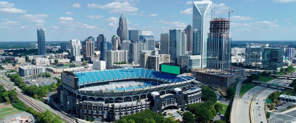 Aerial view of the Uptown Charlotte skyline with Bank of America Stadium in the foreground